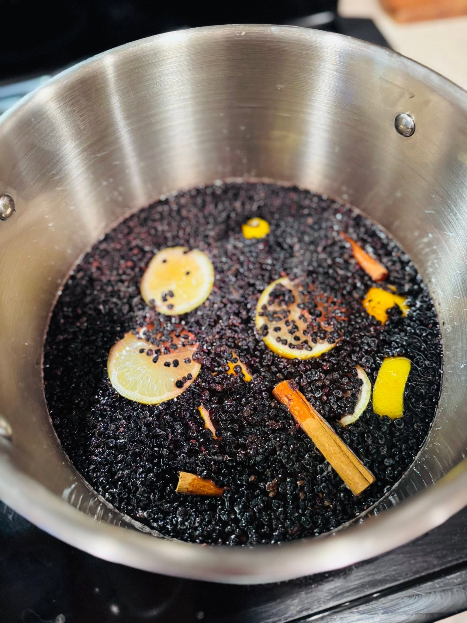 Elderberries simmering with lemon and cinnamon